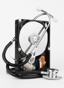 Computer hard drive and a stethoscope, on white background